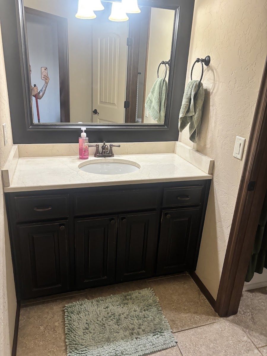 A bathroom vanity, mirror and tiled floor left clean, photographed by Cloud Co