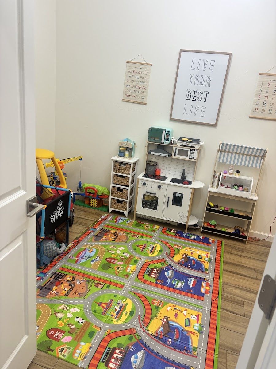 A child's play room with a toy kitchen and play mat, tidied and cleaned, from Cloud Co's own Google photos