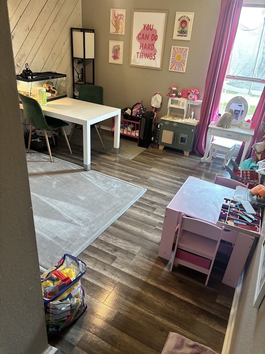 A child's playroom with a vacuumed rug and wood floor, photographed by Cloud Co